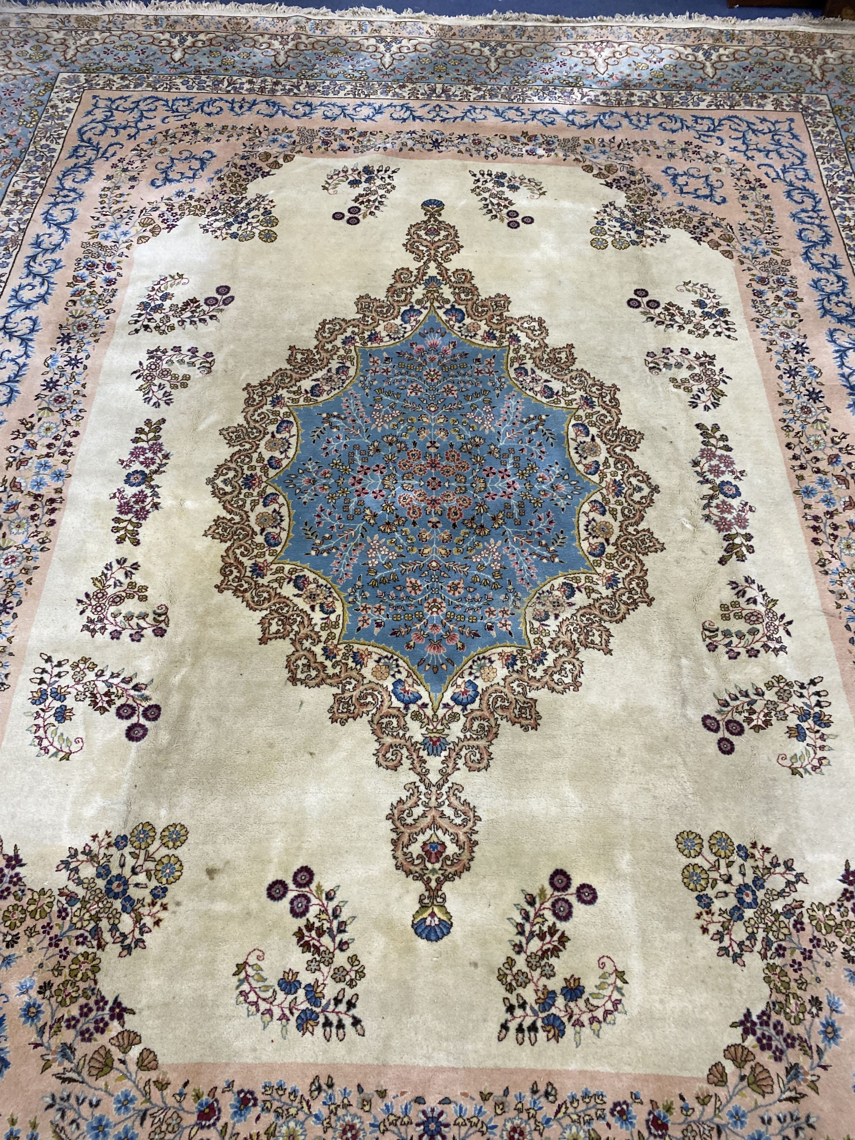 A large Kirman ivory ground carpet, 500 x 410cm